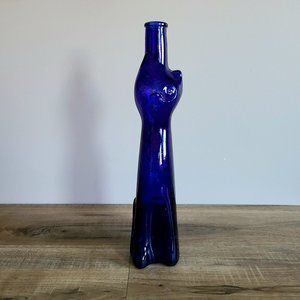 Cobalt blue cat empty glass bottle.